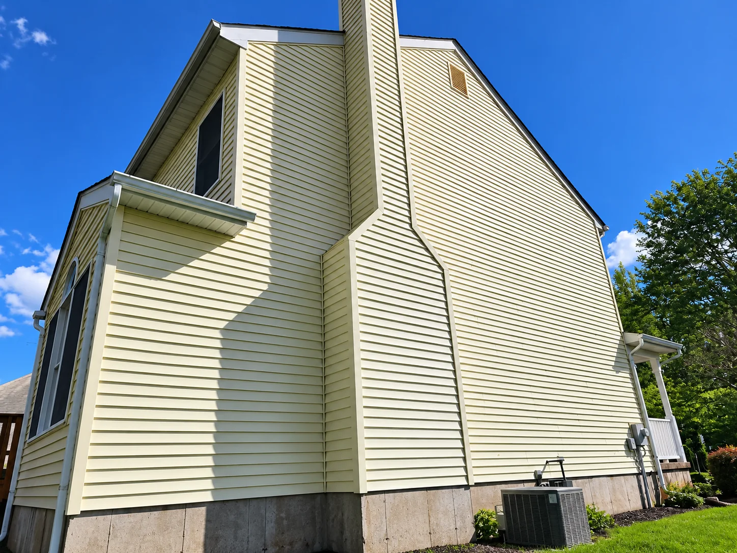 Clean vinyl siding on a residential home after professional exterior washing